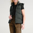 Front view of women’s navy and gray waterproof puffer vest on model – Louvóre apparel